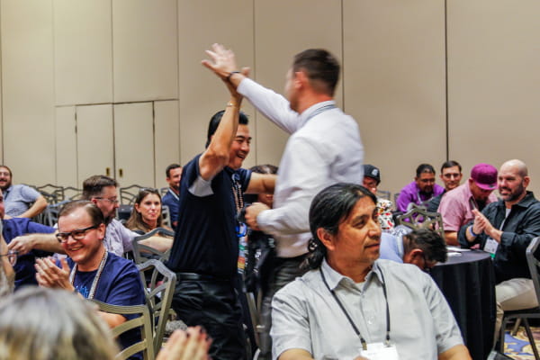 Attendees around a table at a TribalHub event