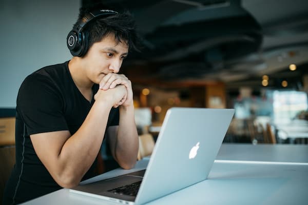 Guy with MacBook - Photo by Wes Hicks on Unsplash - https://unsplash.com/photos/man-wearing-headphones-while-sitting-on-chair-in-front-of-macbook-4-EeTnaC1S4