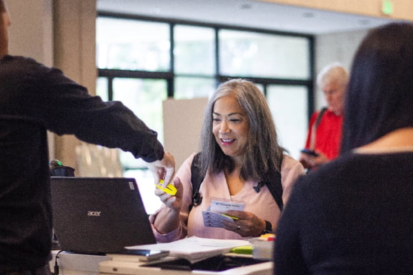 Woman at TribalHub event check-in