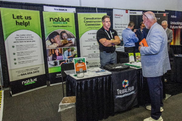 Attendee talking to exhibitor at the TribalNet Conference & Tradeshow